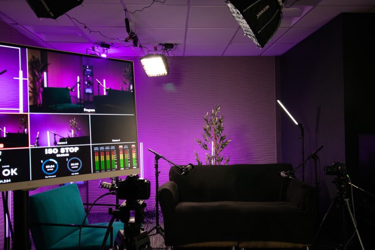 A studio producer reviewing a podcast recording
